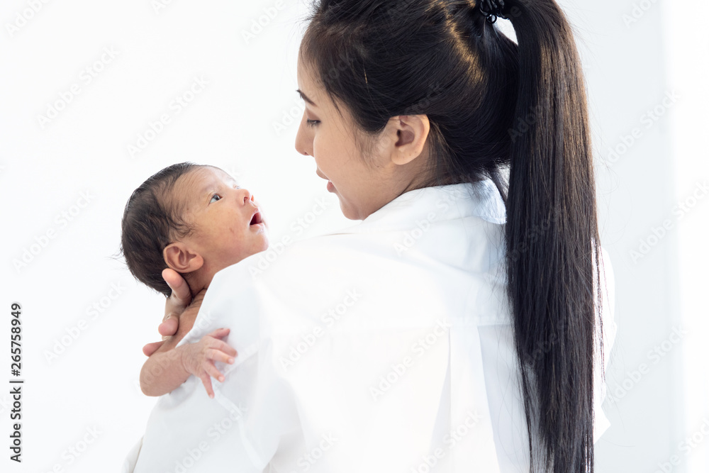Asian newborn baby with mother concept : young mother breast feeds newborn in living room Asian newborn baby with mother concept : young mother breast feeds newborn in living room