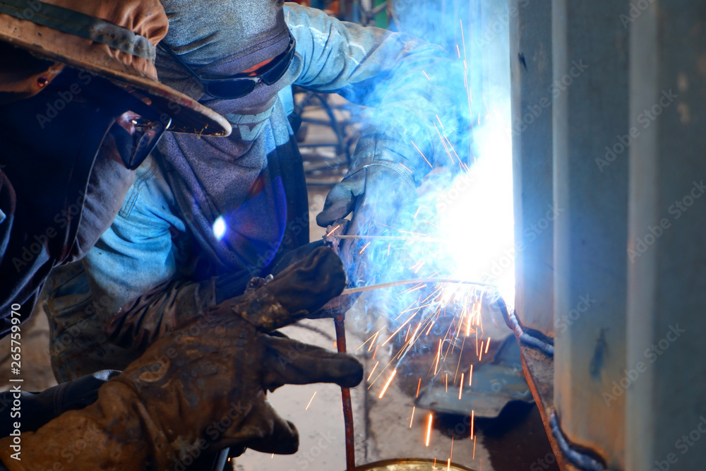 Two touch concepts Two welder working under the sunset with a sky background and container Two touch concepts Two welder working under the sunset with a sky background and container