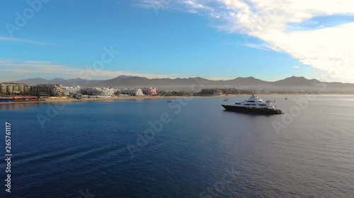 Zoom out over the bahia of Cabo San Lucas Mexico at the sunrise, Luxury Yatch and the coast. photo