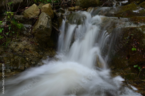 beautiful waterfall with clear water on a mountain stream in the forest