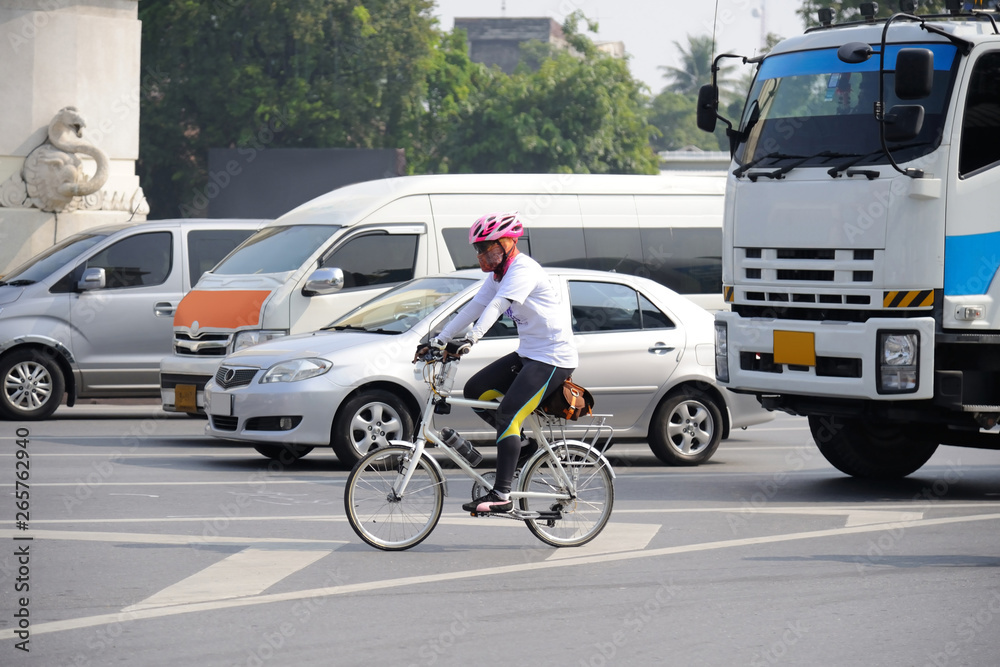 Unidentified cyclist riding his bicycle on Bangkok road Unidentified cyclist riding his bicycle on Bangkok road