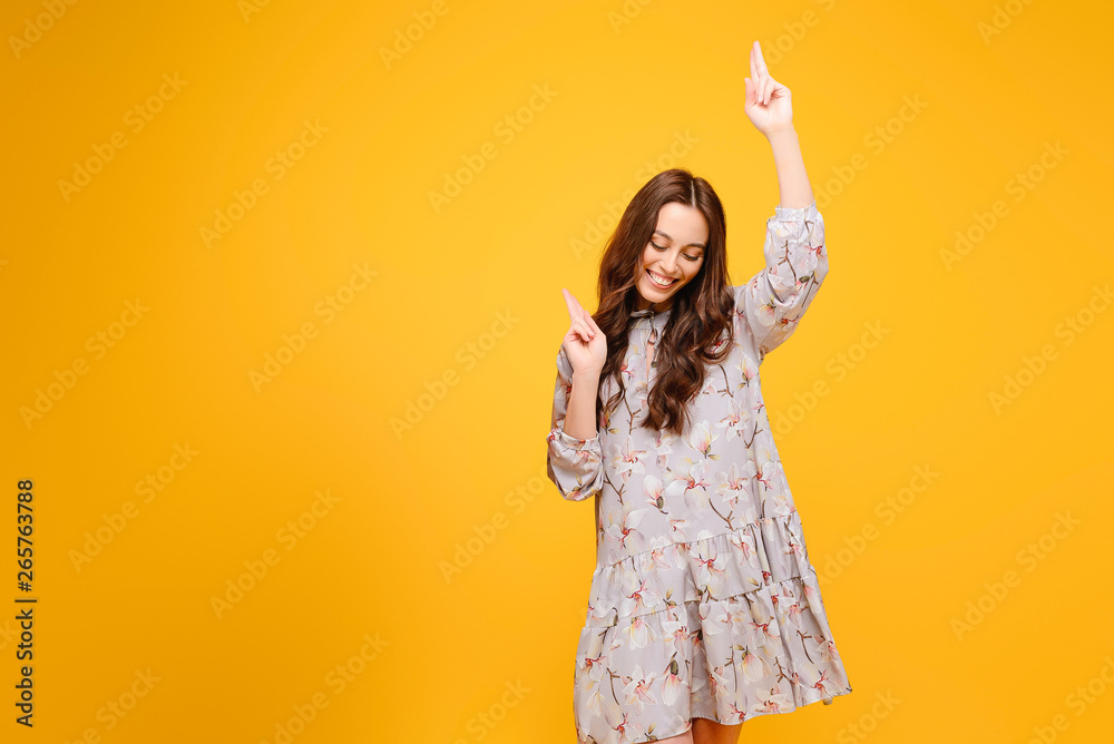 Young woman dancing isolated over yellow background Young woman dancing isolated over yellow background