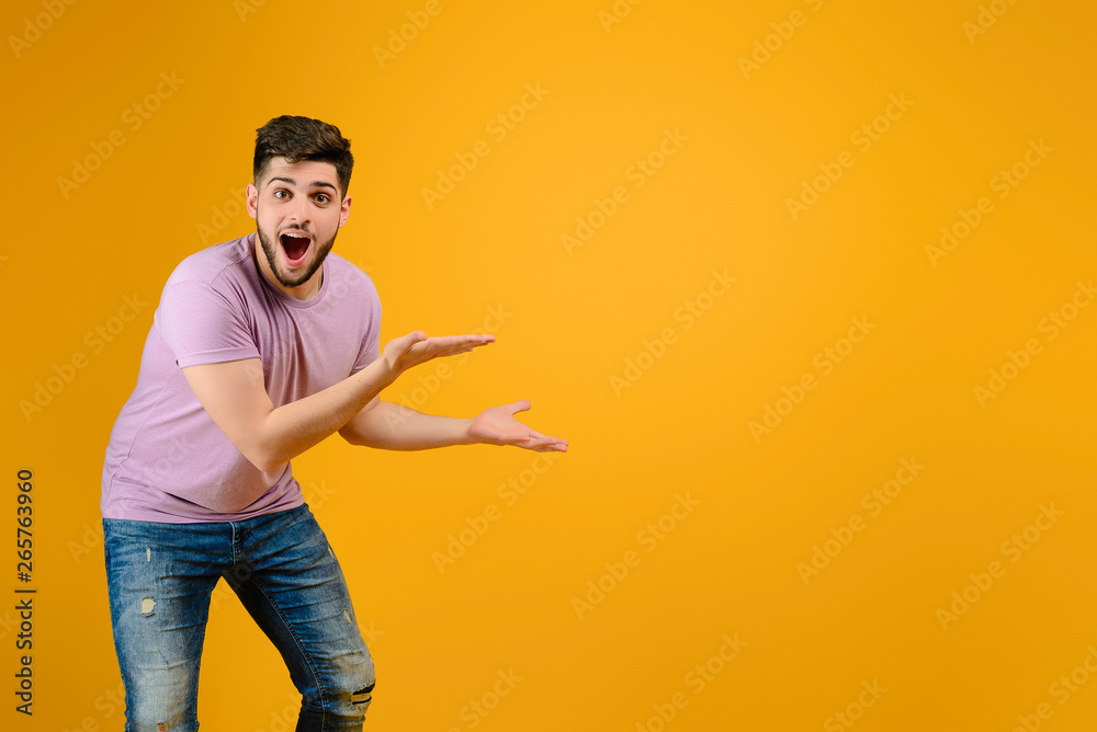 Young handsome man with copyspace isolated over yellow background Young handsome man with copyspace isolated over yellow background