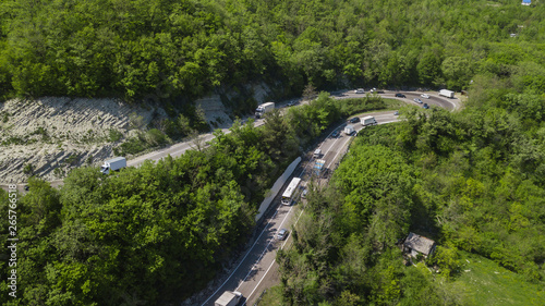 Aerial view of a curved winding road trough the mountains