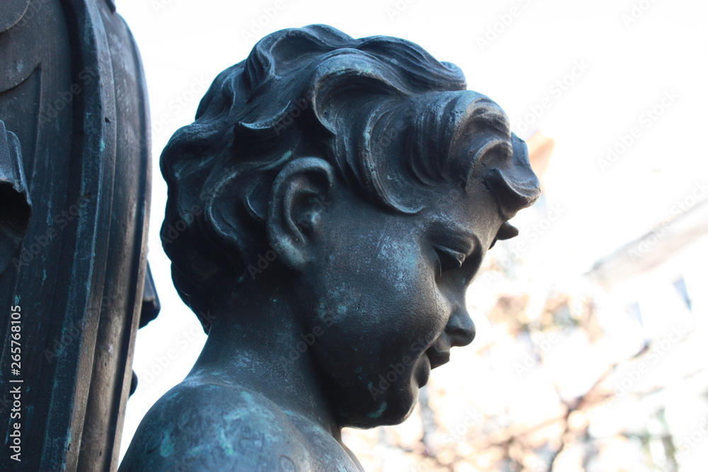 detail of a lantern with the bronze kids   