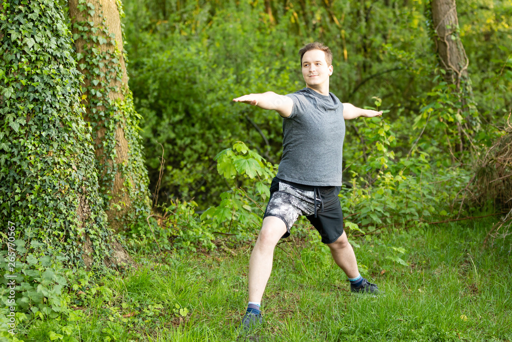 Young man doing yoga exercises in nature Young man doing yoga exercises in nature