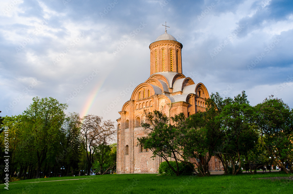Temple of the Holy Mother Paraskevki Friday at the Torgovo Chernigov on the background of a blue, light rain with a rainbow sky. Ukraine