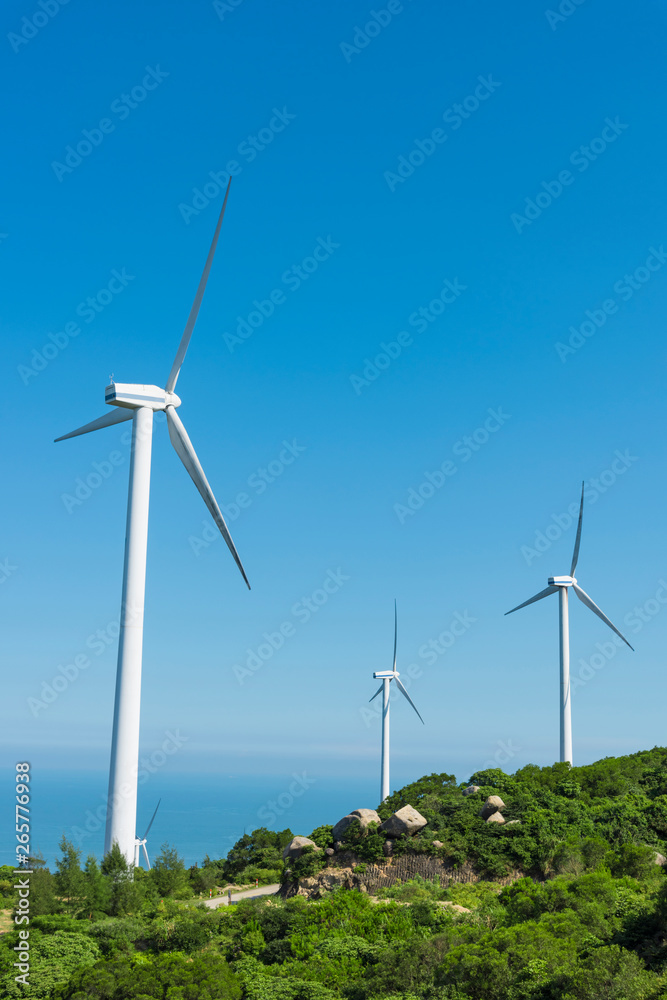 Wind turbines in the mountains near the sea Wind turbines in the mountains near the sea