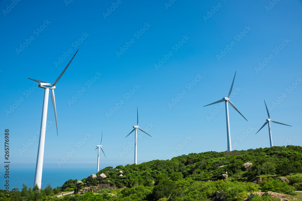 Fototapeta premium Wind turbines in the mountains near the sea