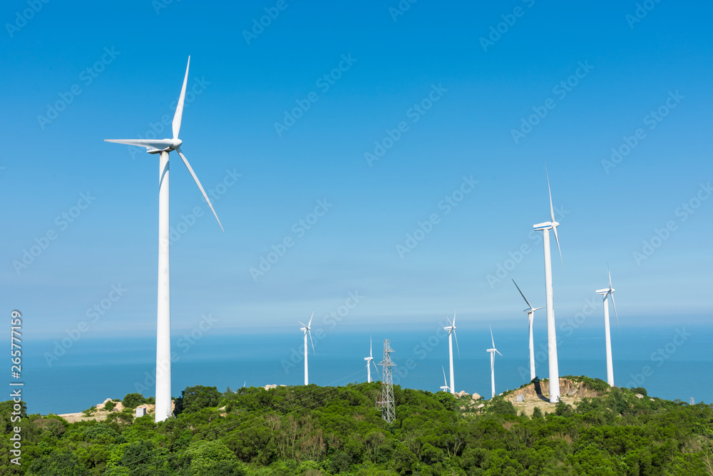 Wind turbines in the mountains near the sea Wind turbines in the mountains near the sea