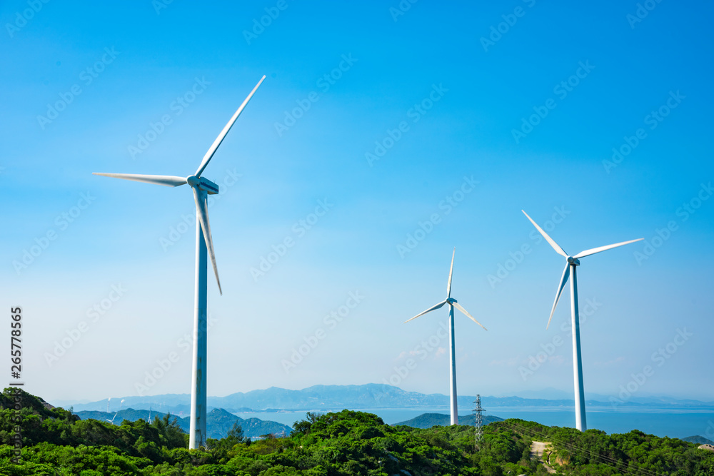 Wind turbines in the mountains near the sea Wind turbines in the mountains near the sea