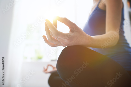 Young woman practicing meditation at home