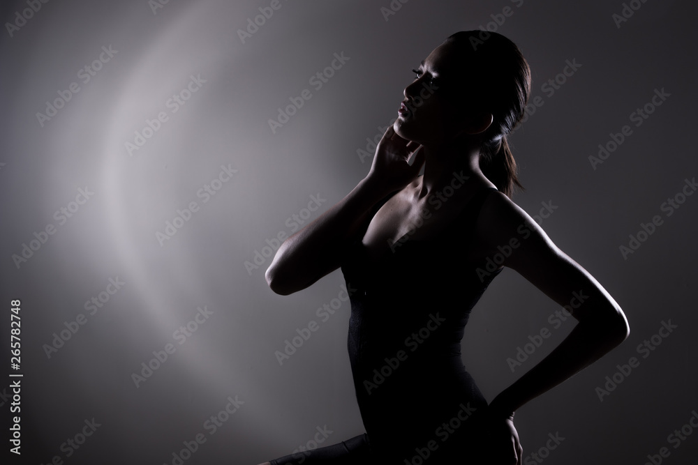 Healthy and Fit Sport Asian Woman in Bodysuit Underwear posing strong and bad feeling weight loss control, black corset body slim dress on asia girl. Studio lighting dark smoke background low exposure