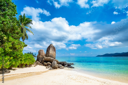 Tropical sandy beach with rock on Seychelles islands