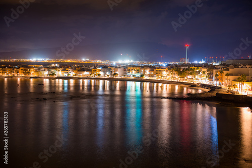 Night view of illuminated coastal town