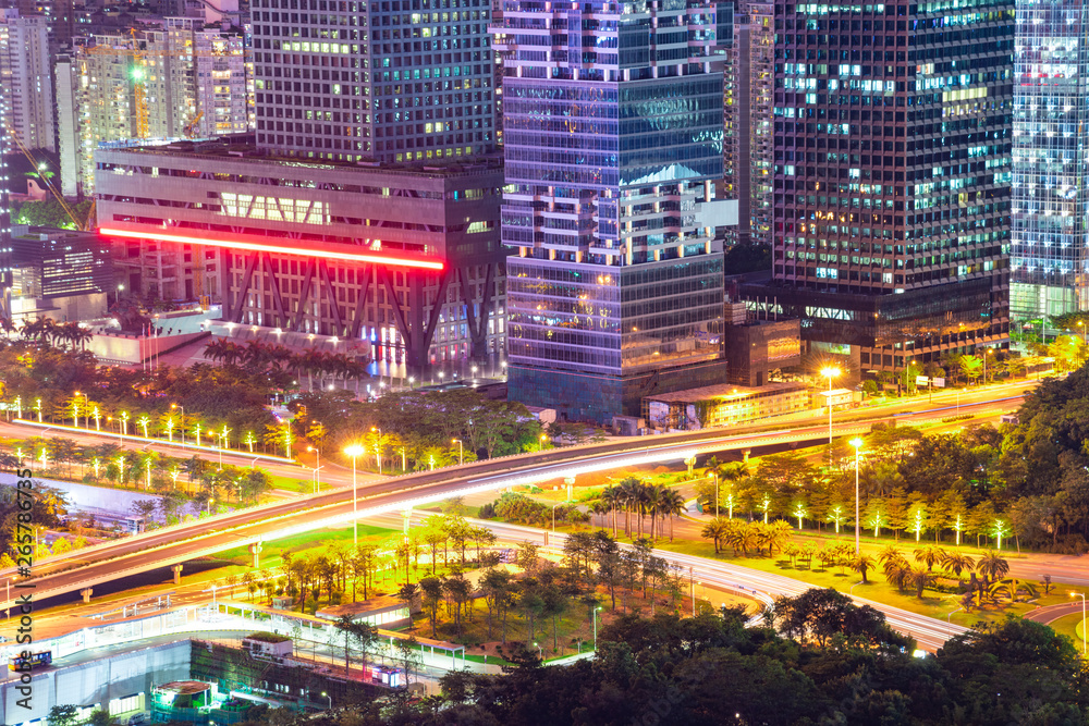Tall buildings and traffic roads in downtown shenzhen at night.