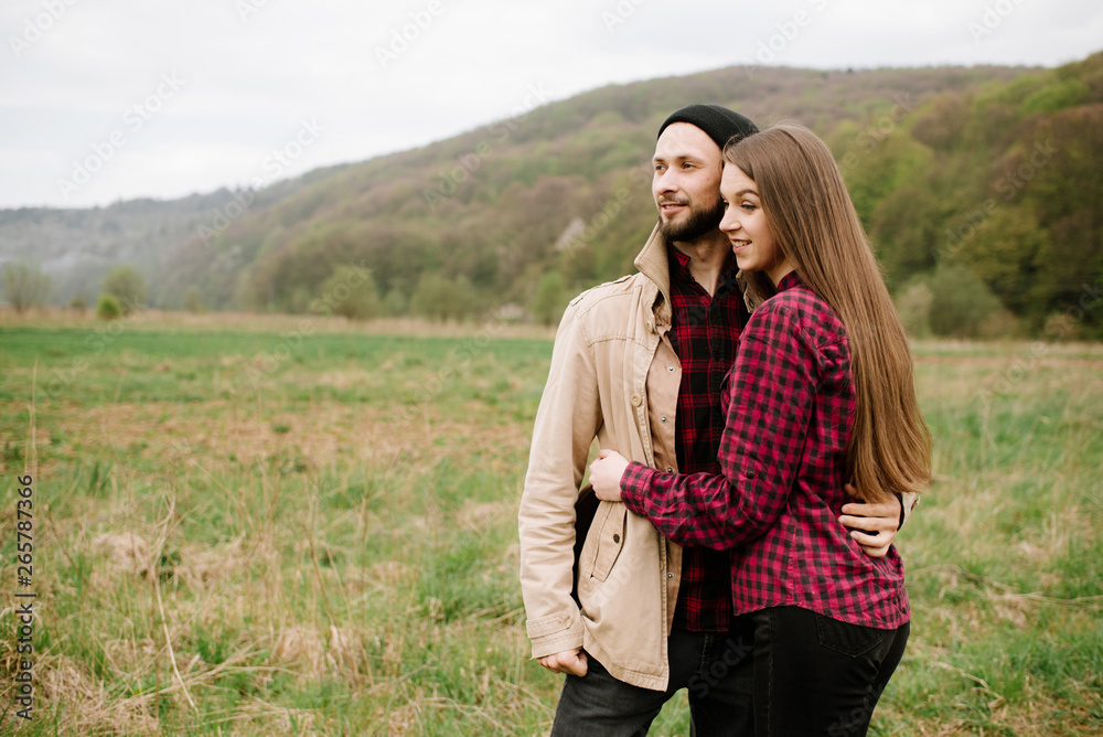 Happy couple walking on the nature at the mountains
