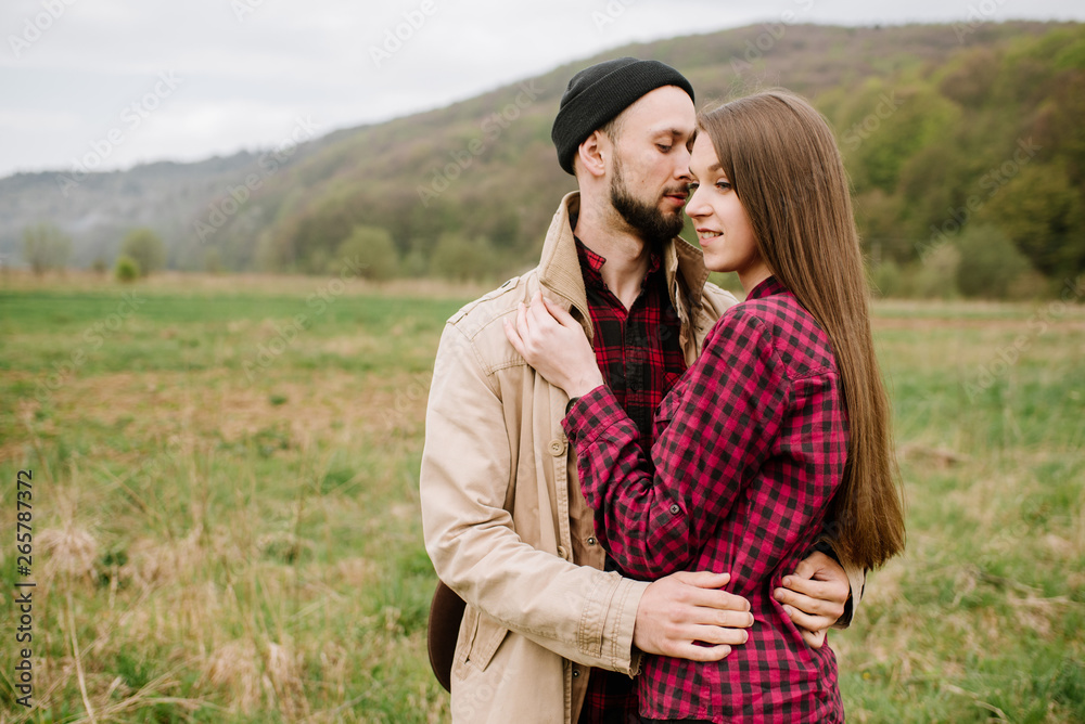 Happy couple walking on the nature at the mountains Happy couple walking on the nature at the mountains