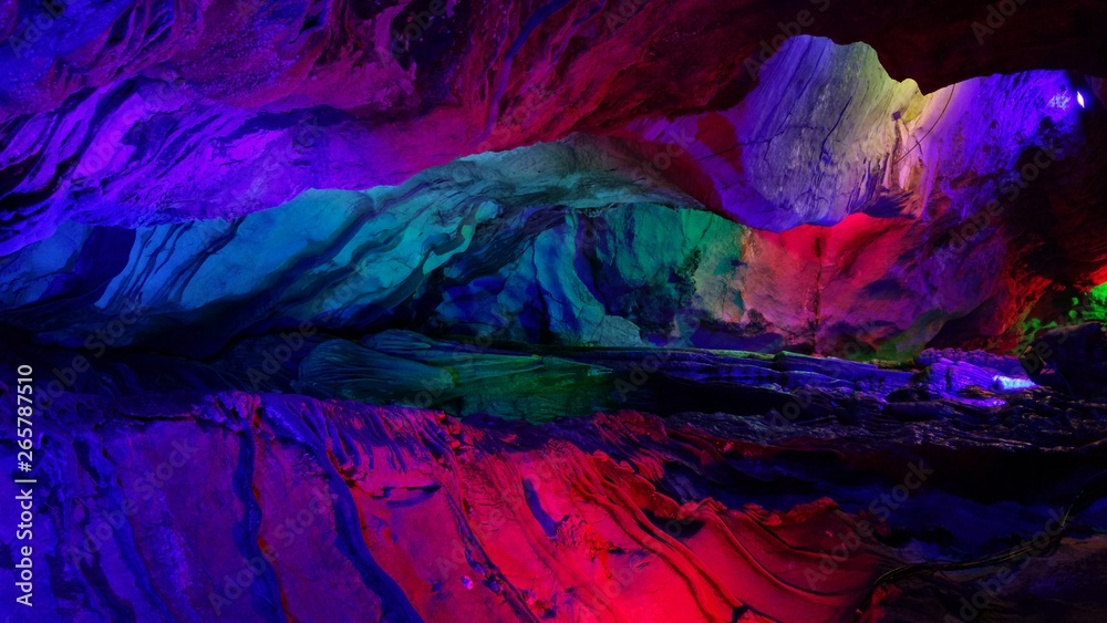 beautiful illuminated multicolored stalactites from karst Reed Flute cave In the cave. Guilin Guangxi China