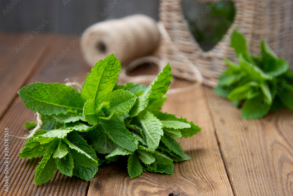 Close up mint leaves on wooden background. Summer drinks or dessert ingredient. Rustic style. Isolated mint Close up mint leaves on wooden background. Summer drinks or dessert ingredient. Rustic style. Isolated mint
