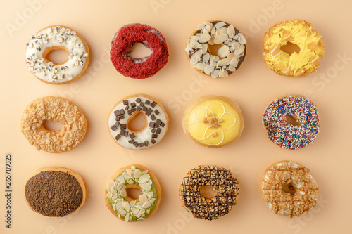 food background of assortment of donuts on orange background