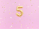 Five year birthday. Number 5 flying foil balloon on pink. Five-year anniversary gold confetti background. 3d rendering