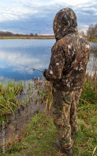 The fisherman catches fish on the bait in the pond