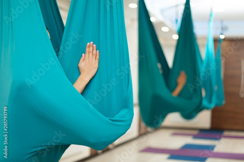 Woman meditation in hammock. fly yoga stretching exercises in gym. Fit and wellness lifestyle