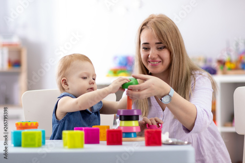 cute woman and kid play together indoor