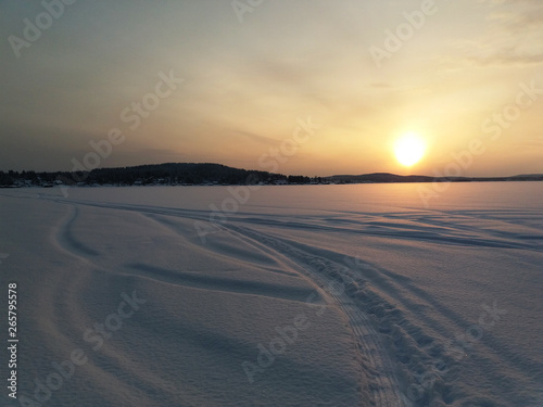 Sunset over the snowy lake