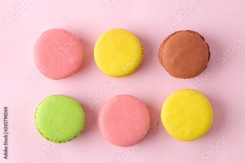 Macarons. french multicolored macaroons cakes. small french sweet cake on bright pink background. Dessert. Sweets. top view