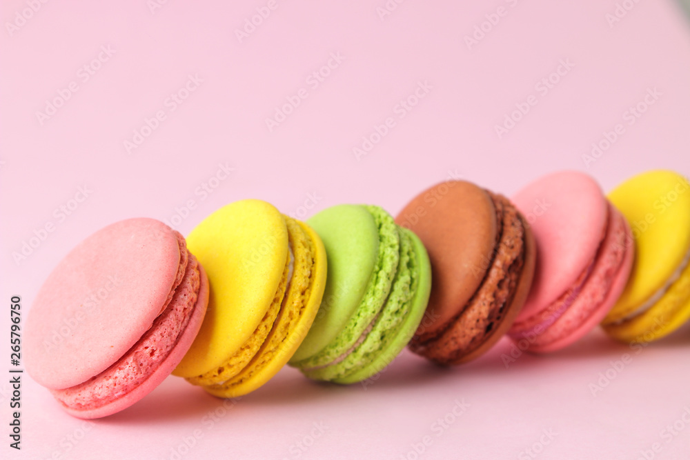 Macarons. french multicolored macaroons cakes. small french sweet cake on bright pink background. Dessert. Sweets.