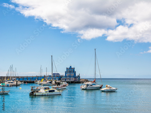 Blue harbormaster house and view over the beautiful sunny harbour of Marina del Sur in Las Galletas. Tenerife, Canary Islands, Spain. Artistic picture. Beauty world. © olenatur