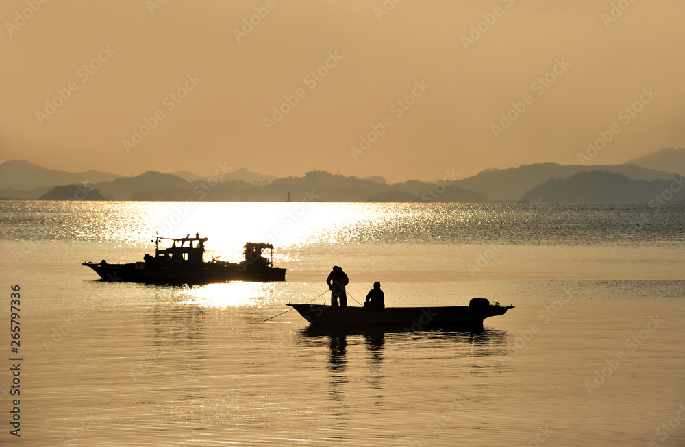 Two Fisherman Working together  Silhouette