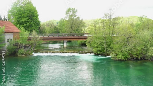 Aerial view of waterfall cascades and old mill on Mreznica river in Croatia, beautiful nature countryside landscape, panning shot photo