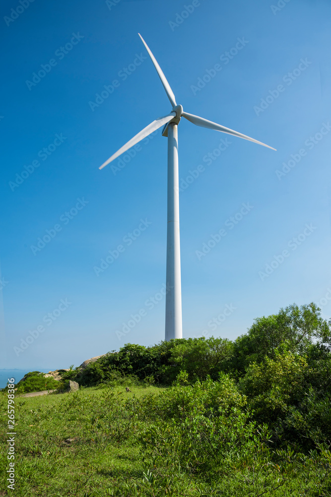 Wind turbines in the mountains near the sea Wind turbines in the mountains near the sea