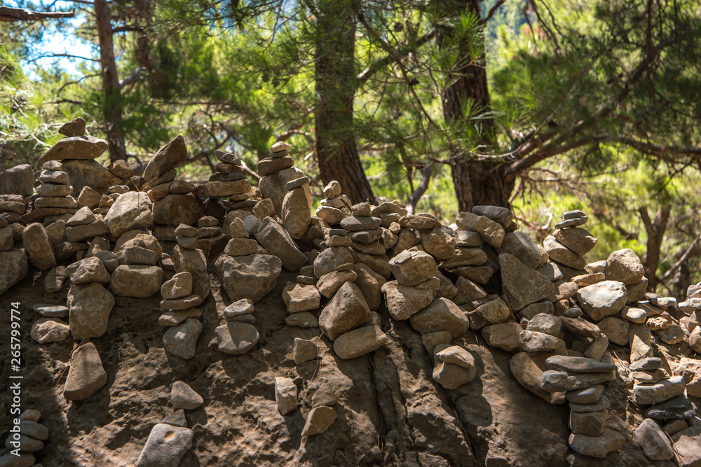 Samaria Gorge. Tourist tradition - a way of stones in the form of slides, in series or in the form of a pyramid. Island of Crete, Greece. Samaria Gorge. Tourist tradition - a way of stones in the form of slides, in series or in the form of a pyramid. Island of Crete, Greece.