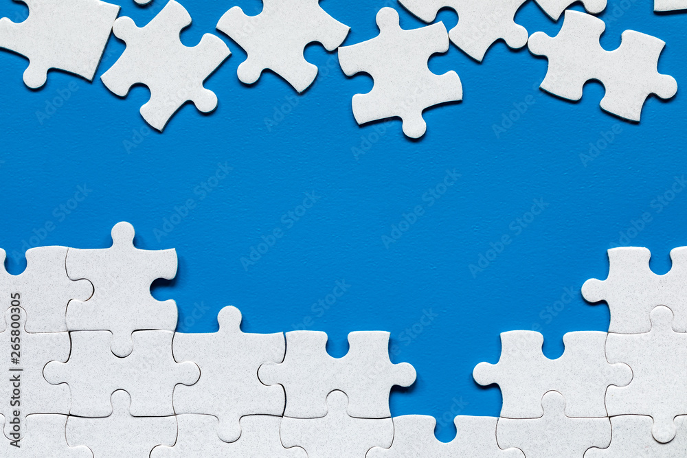 White jigsaw puzzle. White puzzle pieces on color background. Unfinished  white jigsaw puzzle pieces on color background. Stock Photo | Adobe Stock