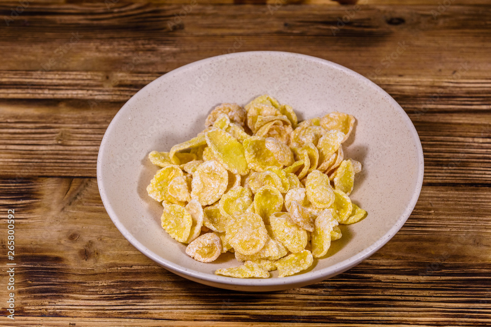 Ceramic plate with cornflakes on a wooden table. Healthy eating Ceramic plate with cornflakes on a wooden table. Healthy eating