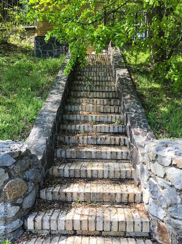 Old stone stair case in the ancient temple with moss.Natural stone stairs landscaping in home garden