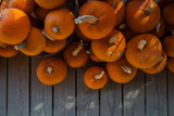 Autumn pumpkin thanksgiving background. Orange pumpkins over wooden table.