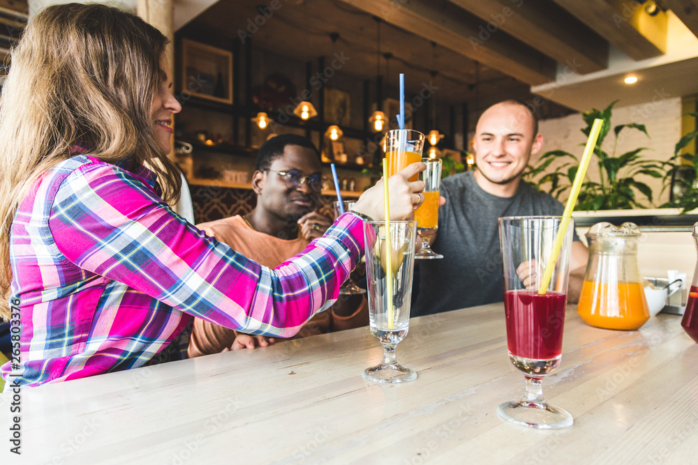 A company of young people having fun, drinking drinks, cocktails, juices in a cafe. Meeting best friends