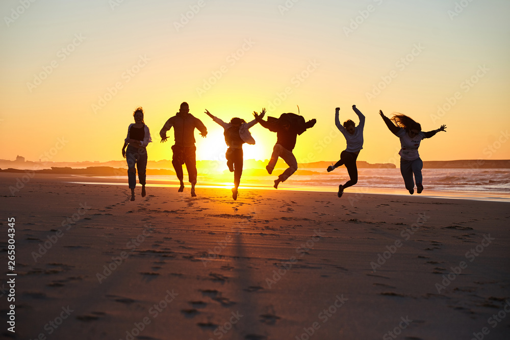 Fototapeta premium Friends jumping on a sunny beach