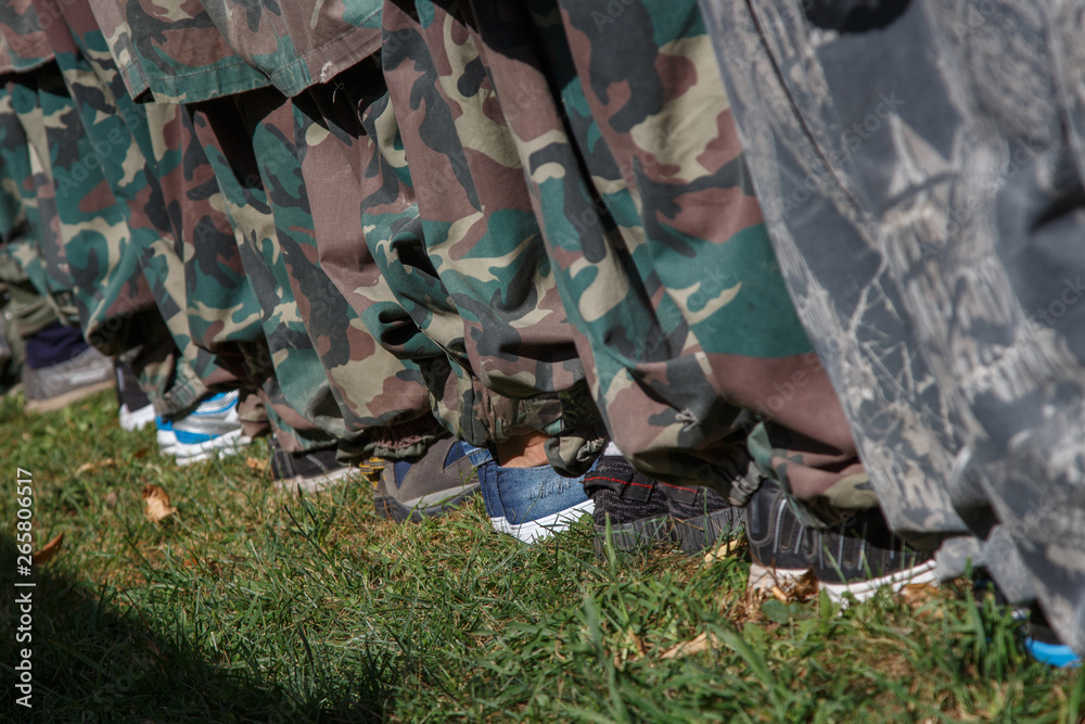 Military training non-professionals. Legs of people in uniform and civilian shoes. Military training non-professionals. Legs of people in uniform and civilian shoes.