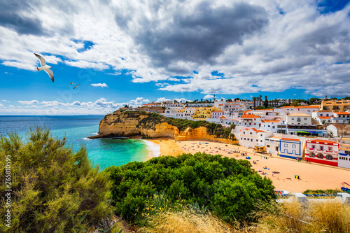 View of Carvoeiro fishing village with beautiful beach, Algarve, Portugal. View of beach in Carvoeiro town with colorful houses on coast of Portugal. The village Carvoeiro in the Algarve Portugal. © daliu