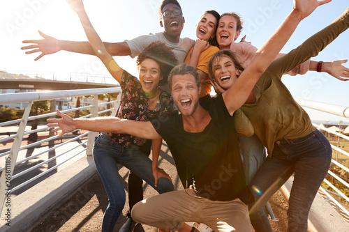 Portrait Of Young Friends Outdoors Posing On Gangway Together