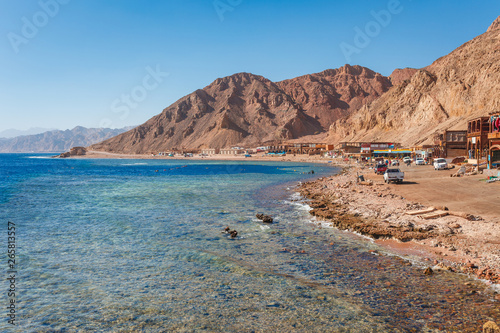 Sunny resort beach at the coast shore of Red Sea in Dahab  Sinai  Egypt  Asia in summer hot. Famous tourist destination Blue Hole near of Sharm el Sheikh. Bright sunny light