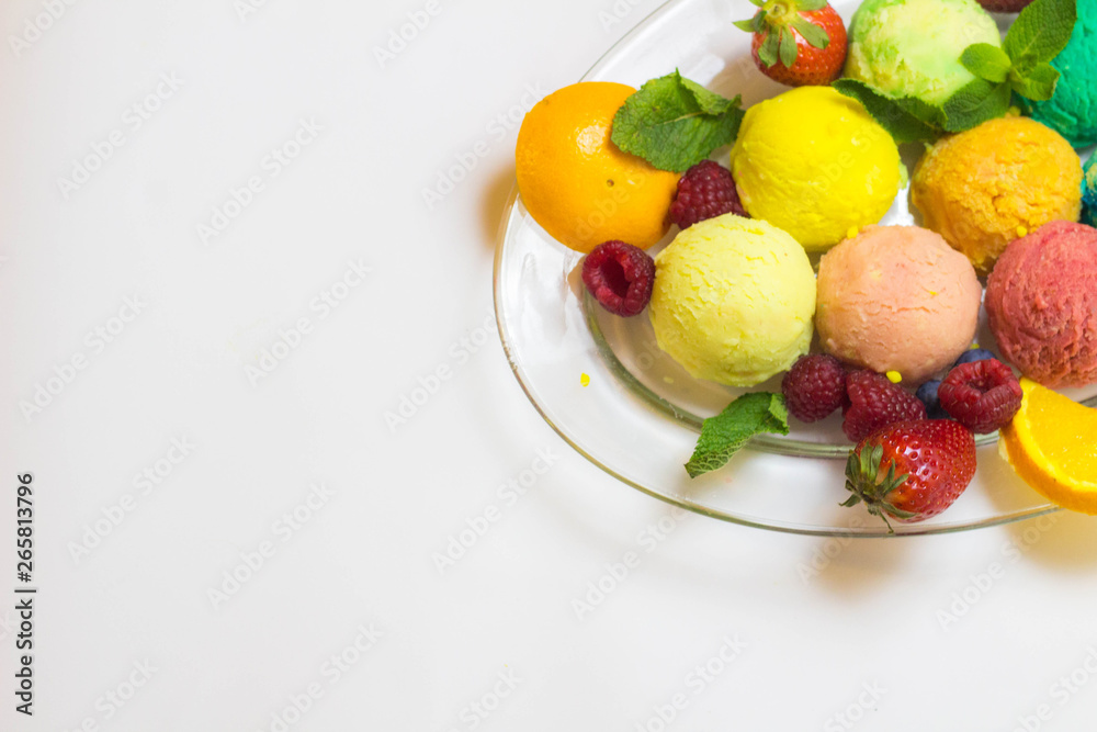 Set of ice cream scoops of different colors and flavours with fruits decoration isolated on white background Set of ice cream scoops of different colors and flavours with fruits decoration isolated on white background