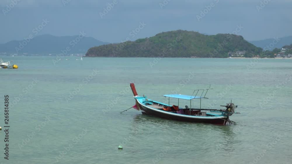 View off the Coast of Phuket Thailand, Thai long tail boats in the Sea on Tropical Beach View off the Coast of Phuket Thailand, Thai long tail boats in the Sea on Tropical Beach