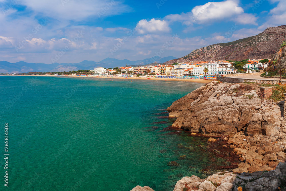 Beach and sea landscape with Sperlonga, Lazio, Italy. Scenic resort town village with nice sand beach and clear blue water in picturesque bay. Famous tourist destination in Riviera de Ulisse